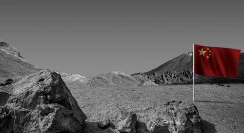 A Chinese flag stands in a barren, monochrome landscape with mountains in the background