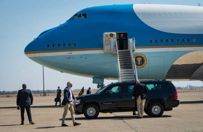 Airplane with stairs and people on the tarmac