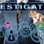 Businessman pointing at investigation themed icons