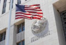 American flag waving in front of a United States court house