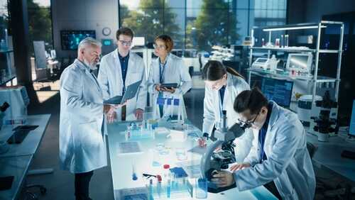 Group of scientists in a laboratory working together on experiments