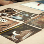 Collection of photographs laid out on a table for analysis