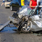 Severely damaged car after a collision on the road