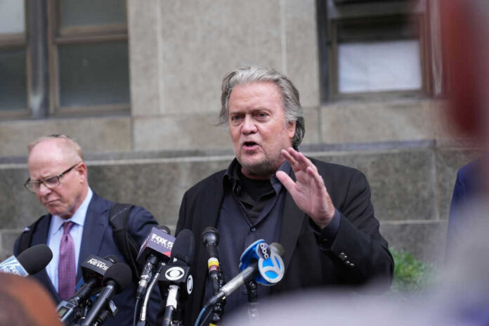 2199493807 Man speaking at press conference with microphones.