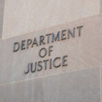 Daycare Horror Tied To Ex-Lawmaker Department of Justice sign on building wall.