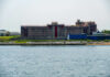 Nuclear Near-Miss In Iran Building by the water with fenced perimeter
