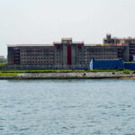 Building by the water with fenced perimeter