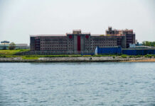 Building by the water with fenced perimeter