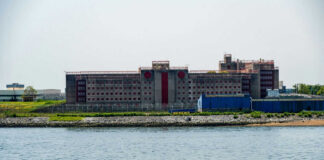 Building by the water with fenced perimeter