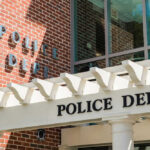 Police department building with brick facade and signage.