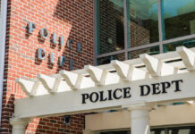 Heartland Bloodbath Stuns Iowa Town Police department building with brick facade and signage.