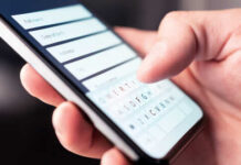 Digital ID Crackdown Hits Home Close-up of a hand using a smartphone to enter information
