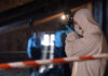 Rushed Narrative Sparks LA Backlash Forensic investigator in protective gear photographing a crime scene in an attic