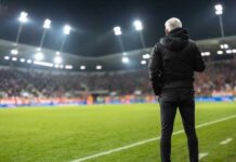 Gambling Bombshell Shakes Texas Tech Soccer coach observing the game from the sidelines at night