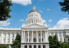 White domed capitol building with blue sky background