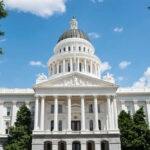White domed capitol building with blue sky background