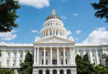 White domed capitol building with blue sky background