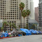 Street lined with tents and makeshift shelters downtown.