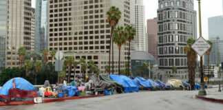 Street lined with tents and makeshift shelters downtown.