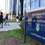 People walking outside Yale School of Management building