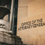 Walz’s Pardon, Then the Plane Ticket Office of the Attorney General building entrance sign