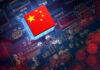 Chinese flag on a microchip over a blue circuit board