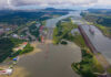 Aerial view of the Panama Canal with ships and surrounding landscape