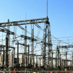 Electrical substation with metal towers and wires.