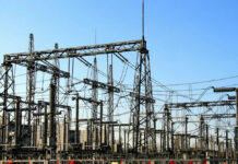 Electrical substation with metal towers and wires.