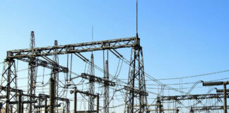 Electrical substation with metal towers and wires.