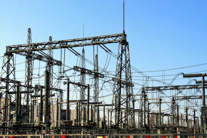 2398018651 Electrical substation with metal towers and wires.