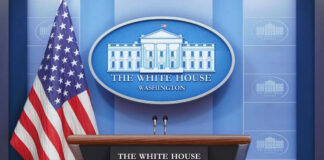 Podium with microphones in front of American flag