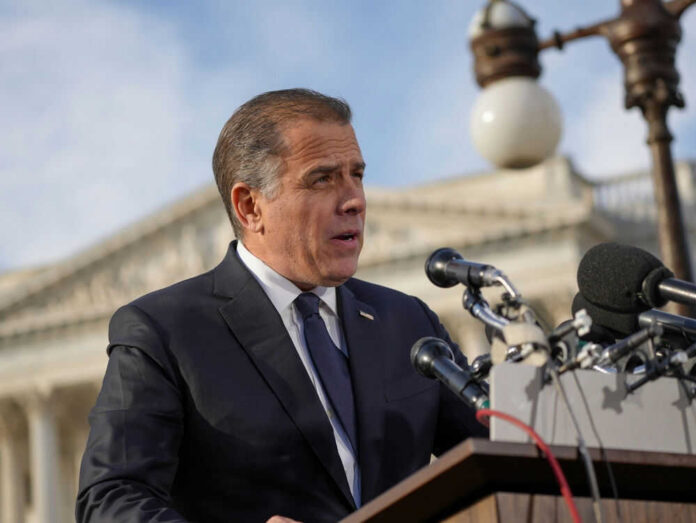 2478300517 Man speaking at a podium with microphones outside