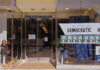 Storefront of Westside Democratic Headquarters with signs.