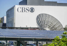 CBS building with large satellite dish and solar panels.