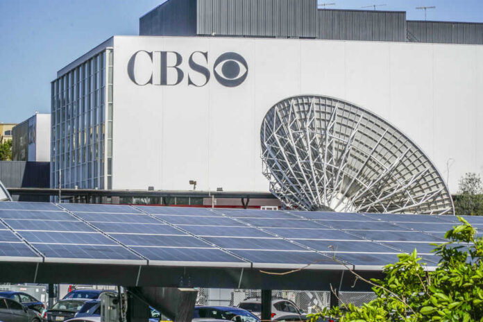 CBS building with large satellite dish and solar panels.