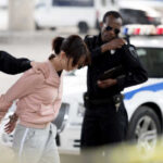 Police officers arresting a suspect in an urban environment