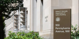Exterior view of the Robert F. Kennedy Department of Justice Building with a sign