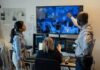 Motel Room Meltdown? Footage Missing Three professionals analyzing security footage on multiple screens