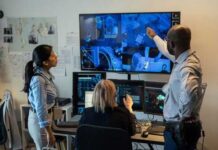 Motel Room Meltdown? Footage Missing Three professionals analyzing security footage on multiple screens