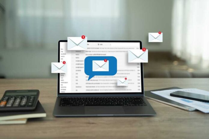 Man,Reading,E-mail,On,Smartphone,Email,Inbox,And,Email,With Laptop displaying email notifications with a message icon