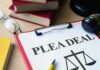 Document titled 'PLEA DEAL' with a gavel and legal books in the background