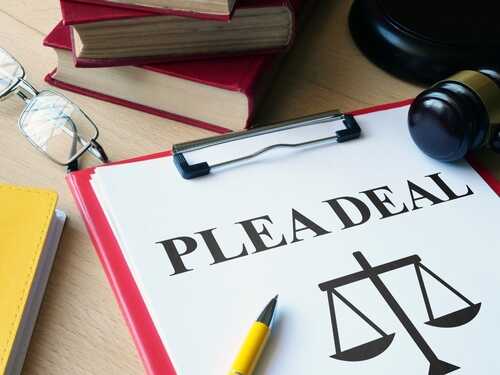 Plea,Deal,Or,Agreement,Is,Shown,As,Legal,Concept Document titled 'PLEA DEAL' with a gavel and legal books in the background