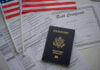 Crimes, DUI, Fraud — Then This A U.S. passport, birth certificate, and American flags on a table