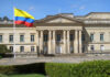 Stolen Identity Vote Sparks Federal Prison Historic building with Colombia flag in front.