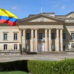 Stolen Identity Vote Sparks Federal Prison Historic building with Colombia flag in front.