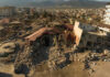 Cityscape with collapsed buildings and rubble after earthquake