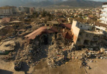 Cityscape with collapsed buildings and rubble after earthquake