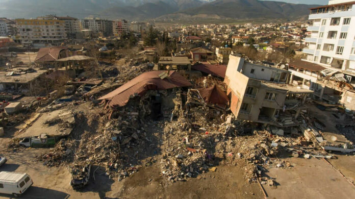 Cityscape with collapsed buildings and rubble after earthquake