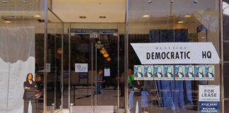 Storefront of Westside Democratic Headquarters with signs.
